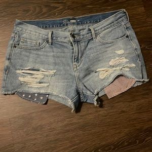 Denim shorts with American flag pocket details.